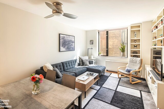 living area with ceiling fan