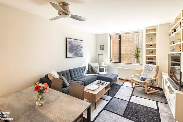 living area featuring a ceiling fan