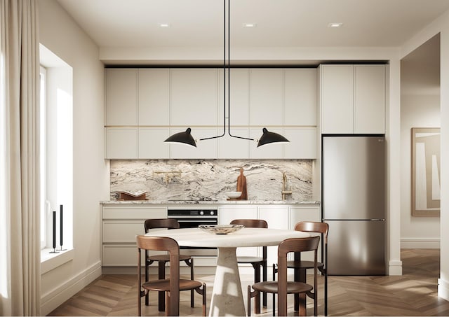 kitchen with wall oven, decorative backsplash, white cabinets, and freestanding refrigerator