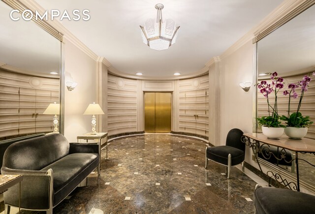 living area with recessed lighting and ornamental molding