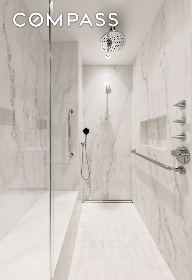 bathroom with a marble finish shower