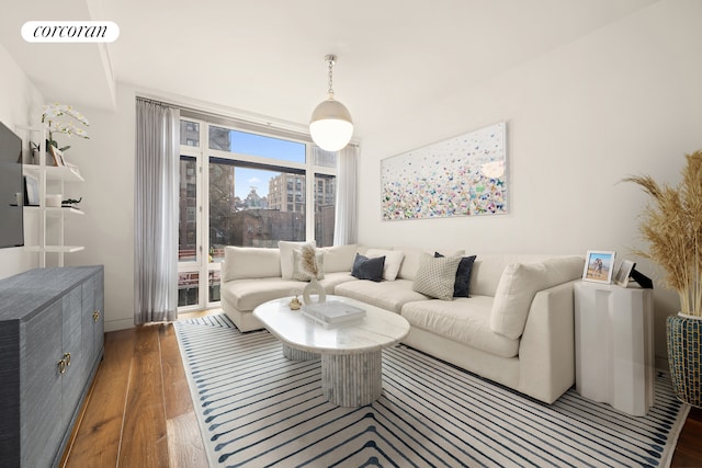 living room featuring a city view, wood finished floors, and visible vents