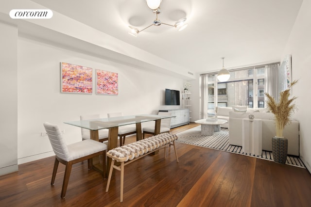 dining room featuring visible vents, baseboards, and wood finished floors