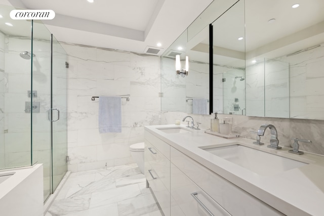 bathroom featuring recessed lighting, a sink, and tile walls
