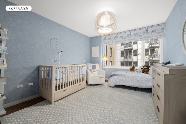 151 W 21st St Unit 6B, New York City, NY 10011 - carpeted bedroom with baseboards and wood finished floors