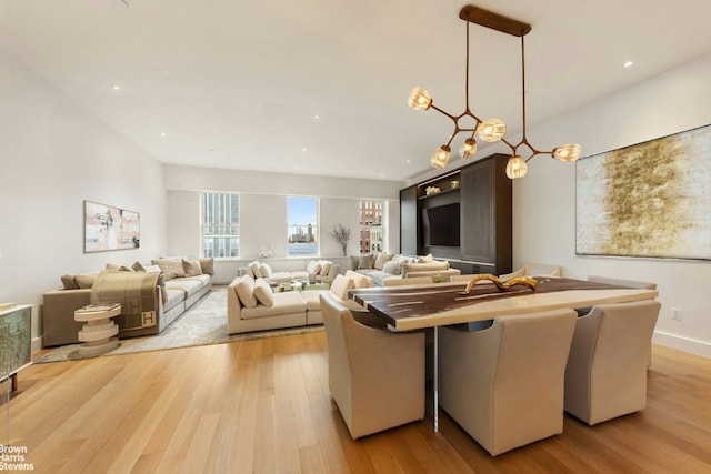 dining area with light wood-style floors and baseboards