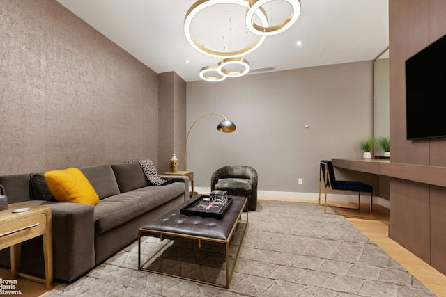 living area with light wood-style flooring, visible vents, and baseboards