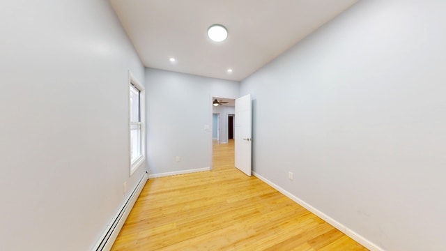 interior space with baseboards, recessed lighting, and light wood finished floors