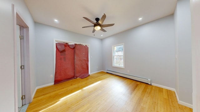 unfurnished bedroom with baseboards, recessed lighting, wood finished floors, and a baseboard heating unit
