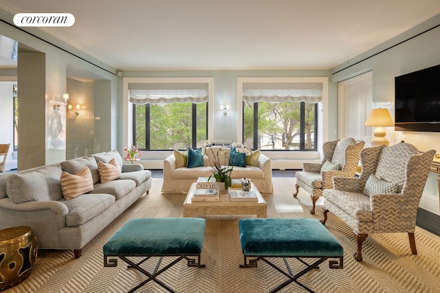 living room featuring a wealth of natural light, visible vents, and crown molding