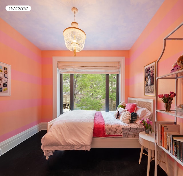 180 E 93rd St Unit 2, New York City, NY 10128 - bedroom featuring a chandelier, wood finished floors, and baseboards