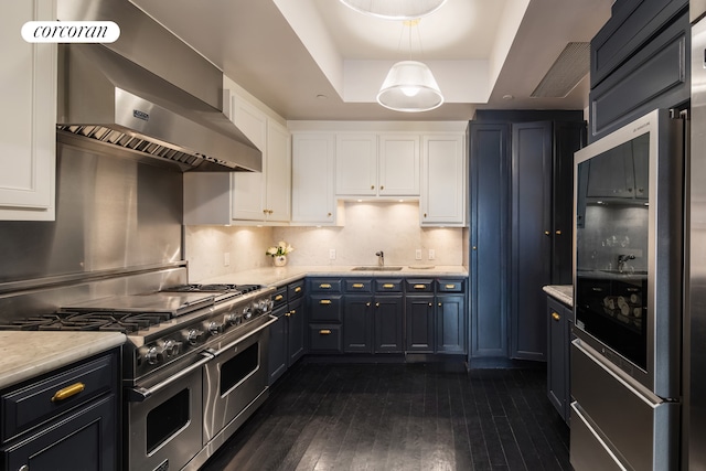 180 E 93rd St Unit 2, New York City, NY 10128 - kitchen featuring double oven range, ventilation hood, white cabinetry, and light countertops
