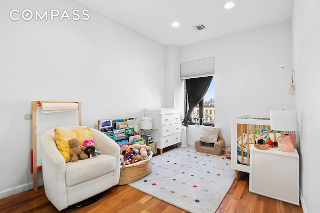 bedroom featuring recessed lighting, baseboards, visible vents, and wood finished floors