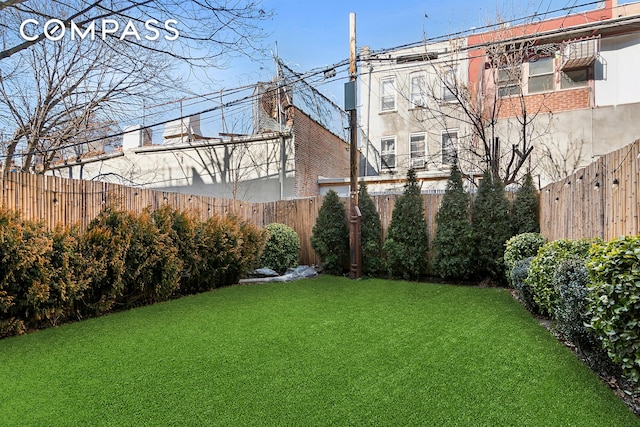 view of yard with a fenced backyard