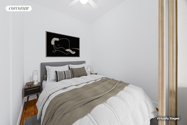 bedroom with ceiling fan, lofted ceiling, wood finished floors, and baseboards