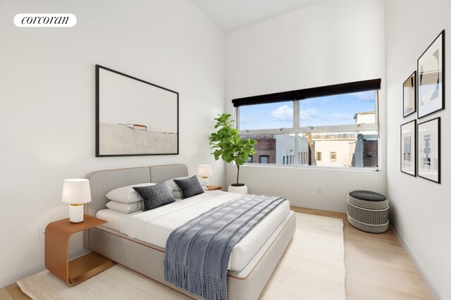 bedroom with light wood-style floors and visible vents