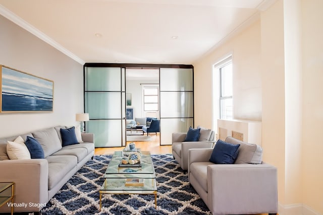 living area with wood finished floors and ornamental molding