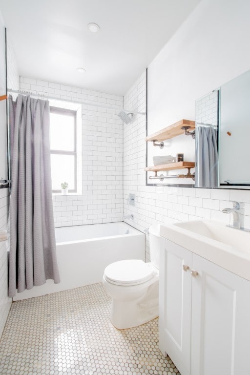 full bathroom featuring tile walls, toilet, bathtub / shower combination, tile patterned floors, and vanity