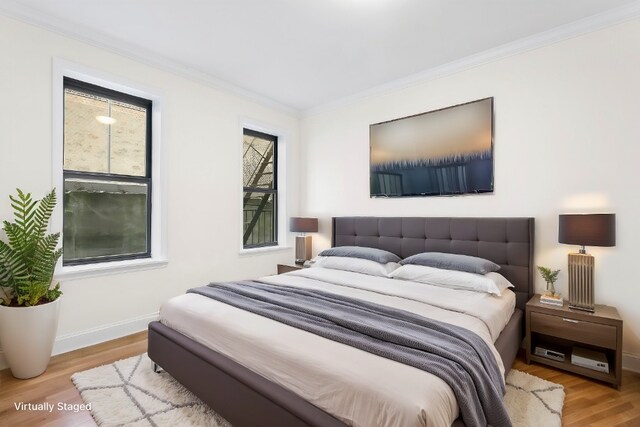 24 Bennett Ave Unit 41A, New York City, NY 10033 - bedroom featuring wood finished floors, crown molding, and baseboards