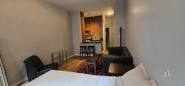 bedroom featuring wood finished floors and baseboards