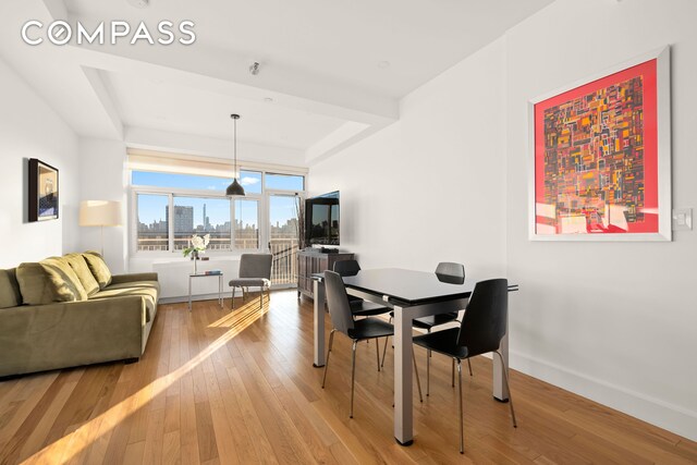 dining area featuring light wood-style floors and baseboards