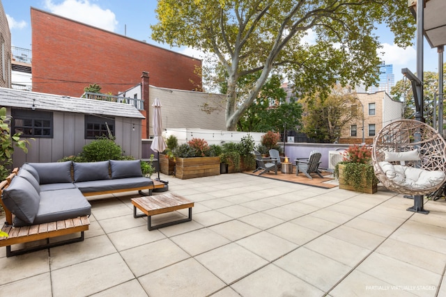 view of patio featuring fence and an outdoor living space