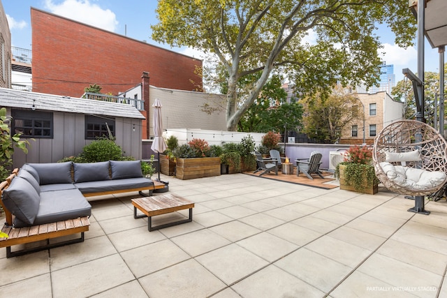 view of patio / terrace featuring fence and outdoor lounge area