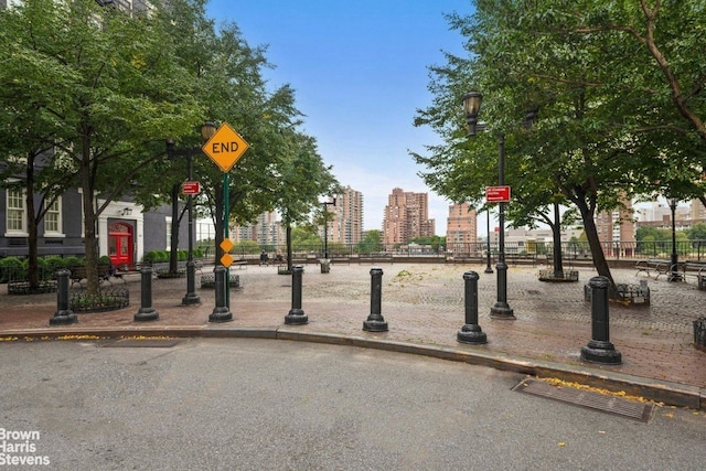 view of property's community featuring fence and a city view