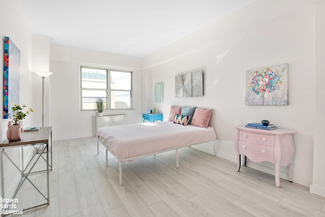 bedroom featuring light wood-type flooring and baseboards