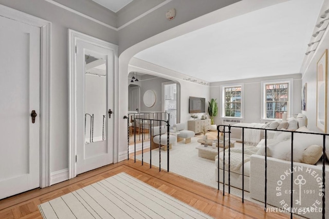 entrance foyer featuring ceiling fan and arched walkways