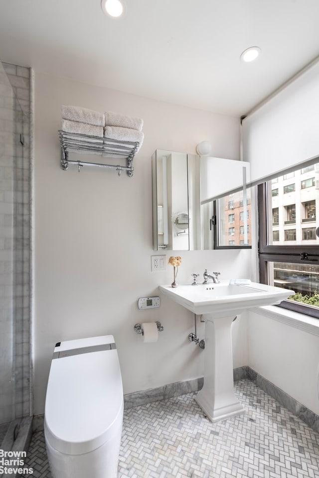 bathroom featuring recessed lighting, baseboards, and toilet