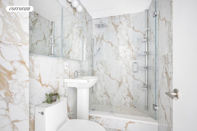 full bath with toilet and a marble finish shower