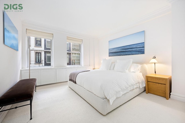 bedroom with crown molding, baseboards, and carpet flooring