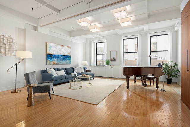 living room with light wood finished floors, a skylight, and baseboards