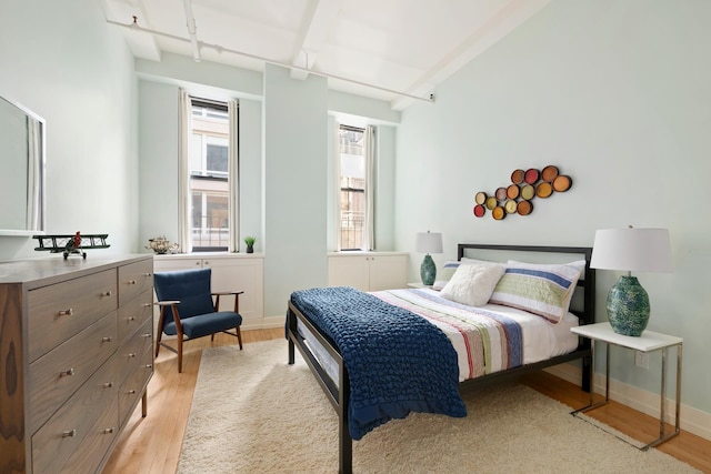 bedroom with baseboards and light wood-style flooring