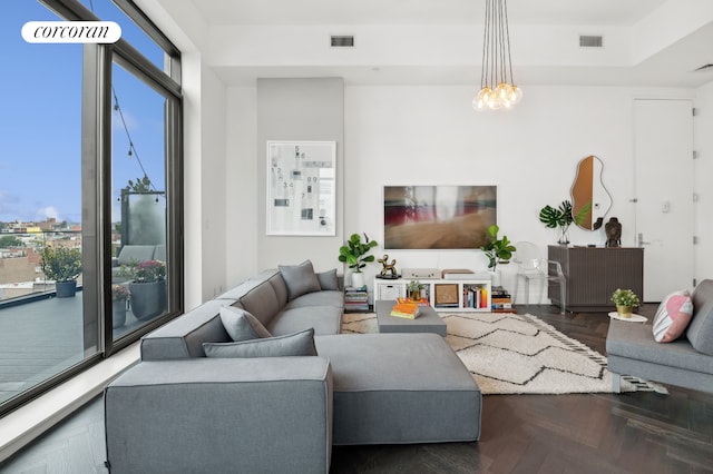 living room with a notable chandelier and visible vents