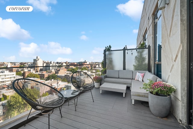 deck with a view of city and an outdoor hangout area