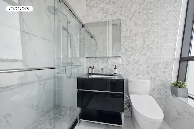 bathroom featuring marble finish floor, toilet, vanity, and a marble finish shower