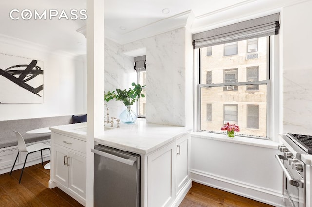 kitchen featuring stainless steel appliances, white cabinetry, crown molding, and dark wood-style floors