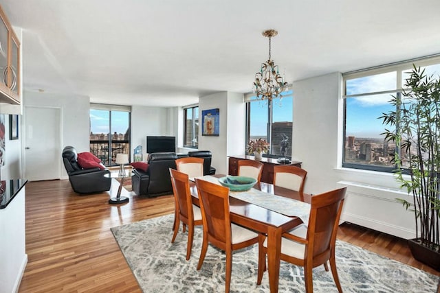 dining area with a notable chandelier and wood finished floors