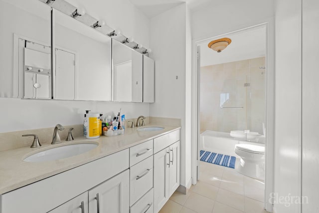 full bath featuring a sink, tile patterned floors, a tile shower, and toilet