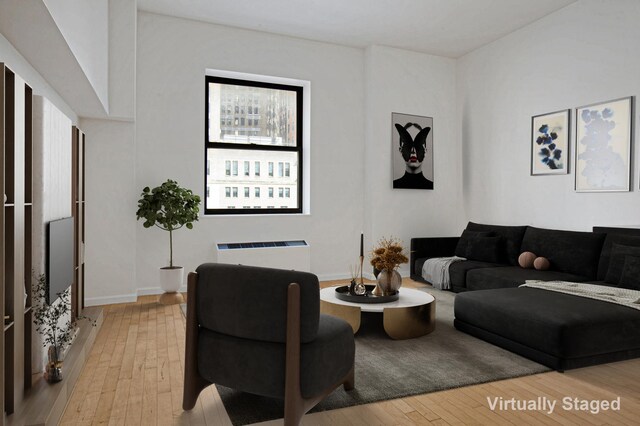 living area featuring light wood-style flooring and radiator