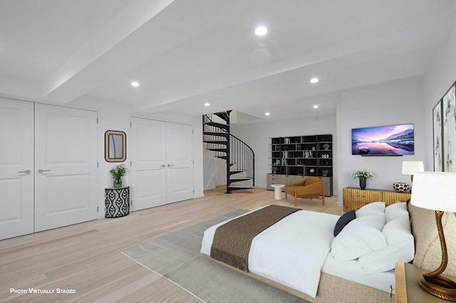 interior space with light wood finished floors, stairway, recessed lighting, and beamed ceiling