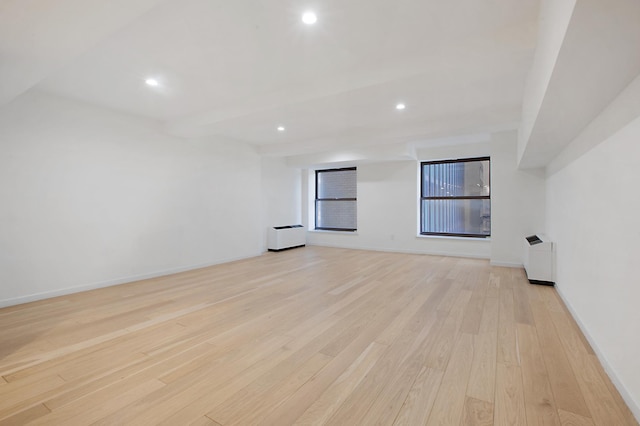 empty room with recessed lighting, baseboards, and light wood finished floors