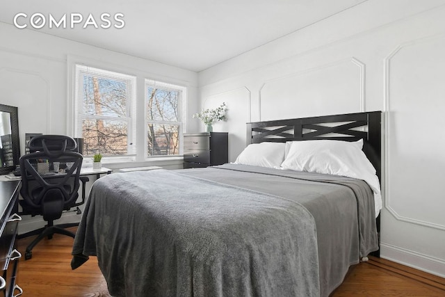 bedroom with dark wood-type flooring