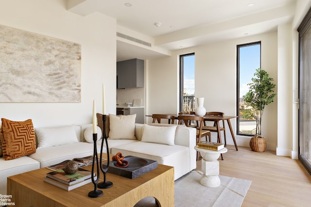 living area featuring light wood-style flooring and recessed lighting