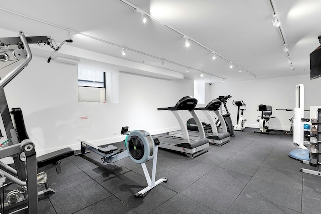 workout area with track lighting and baseboards