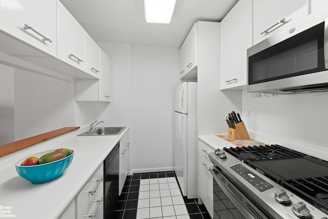 2373 Broadway Unit 935, New York City, NY 10024 - kitchen with stainless steel appliances, light countertops, white cabinetry, and dark tile patterned flooring