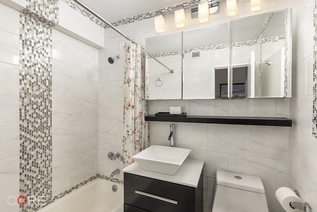 333 E 66th St Unit 9D, New York City, NY 10065 - bathroom with vanity, tile walls, shower / bath combo, and toilet