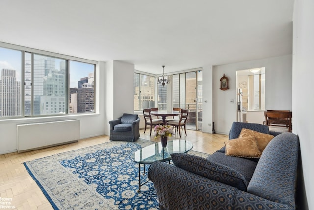 living area with an inviting chandelier, radiator heating unit, and a view of city